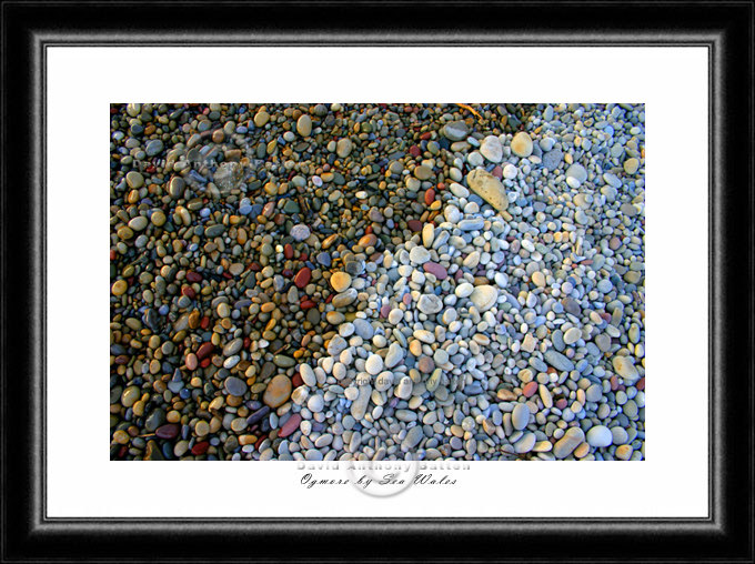 photo of high tides lap wet and dry shingle at ogmore by sea