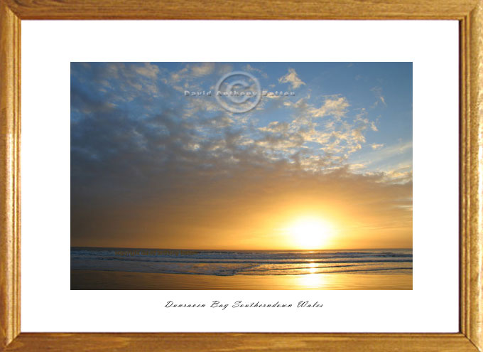 golden and blue sunset photo of dunraven bay wales